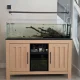 Aquarium stand wrapped in BODAQ W200 wood-look architectural film, replacing its original black appearance with a lighter, modern finish.