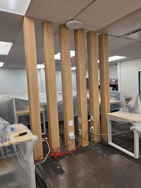 Six completed office posts finished in BODAQ SPW03 wood-look architectural film in Richmond, BC.